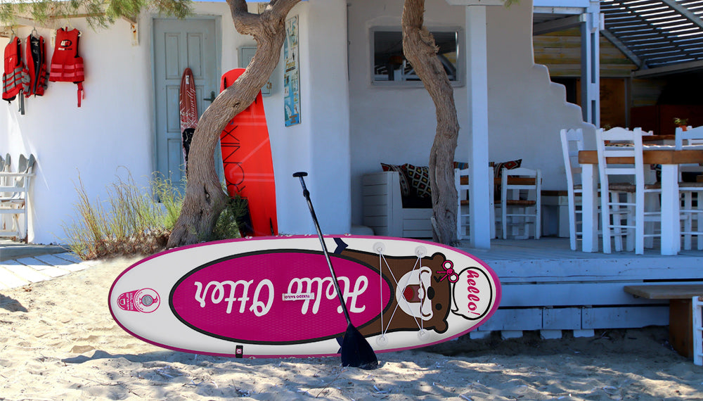 Real photo about a paddle board and a paddle which on the front of a white house