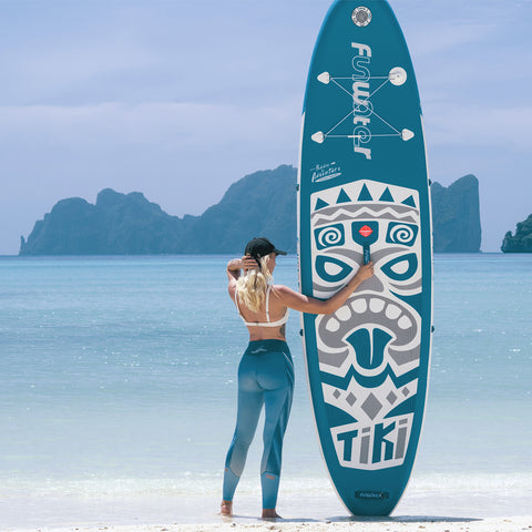 Funwater inflatable stand up paddle board is being held by a woman on the beach